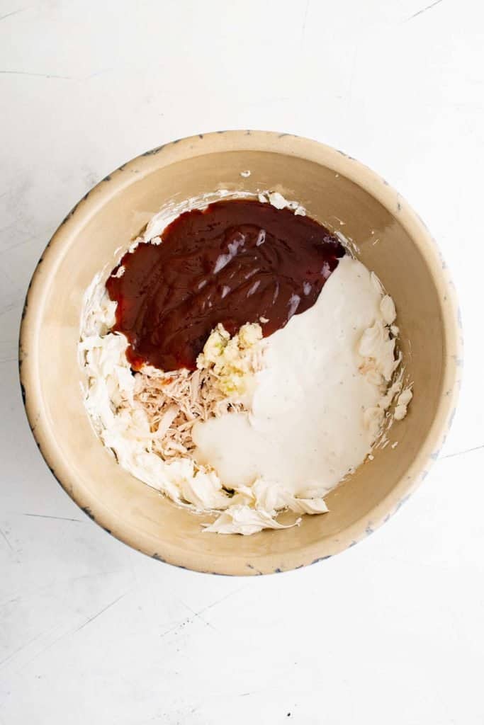 ingredients for bbq chicken dip in a bowl