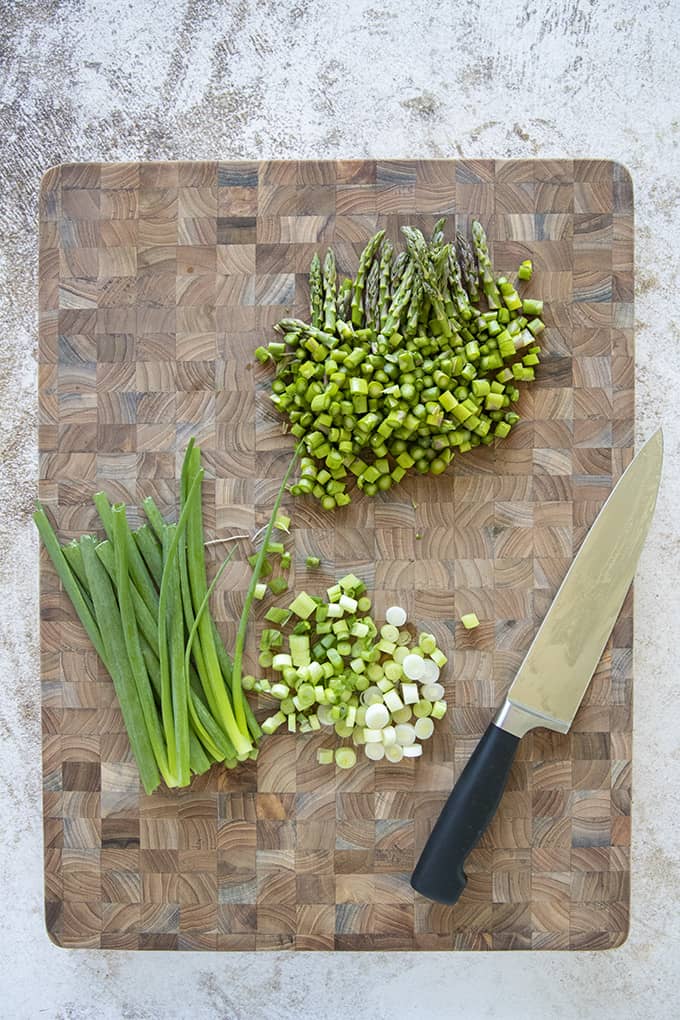 asparagus and green onion on cutting board