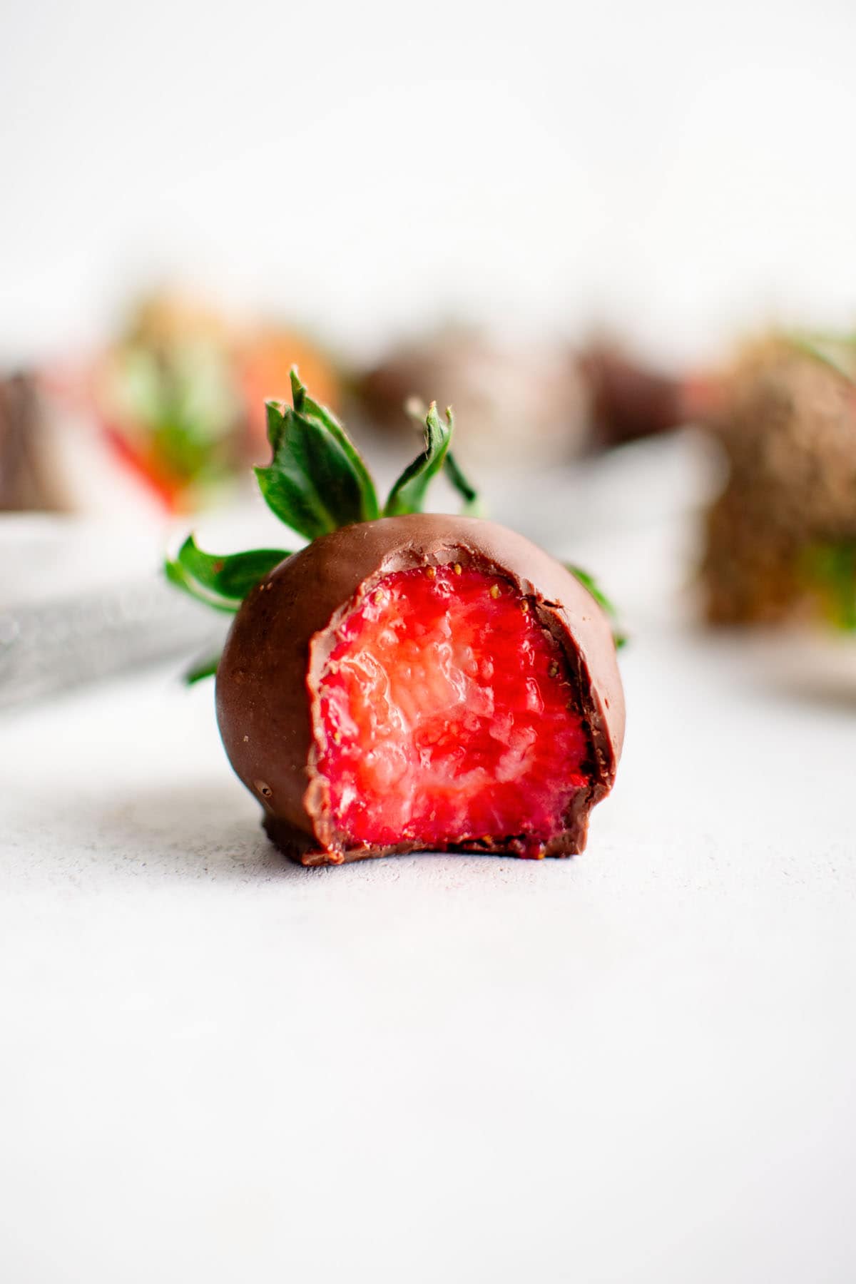 chocolate covered strawberry with a bite taken out of it