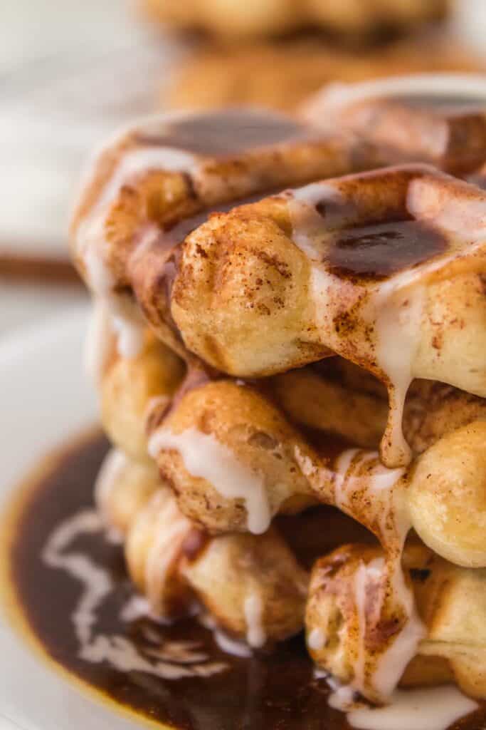 cinnamon roll waffles with glaze on a plate