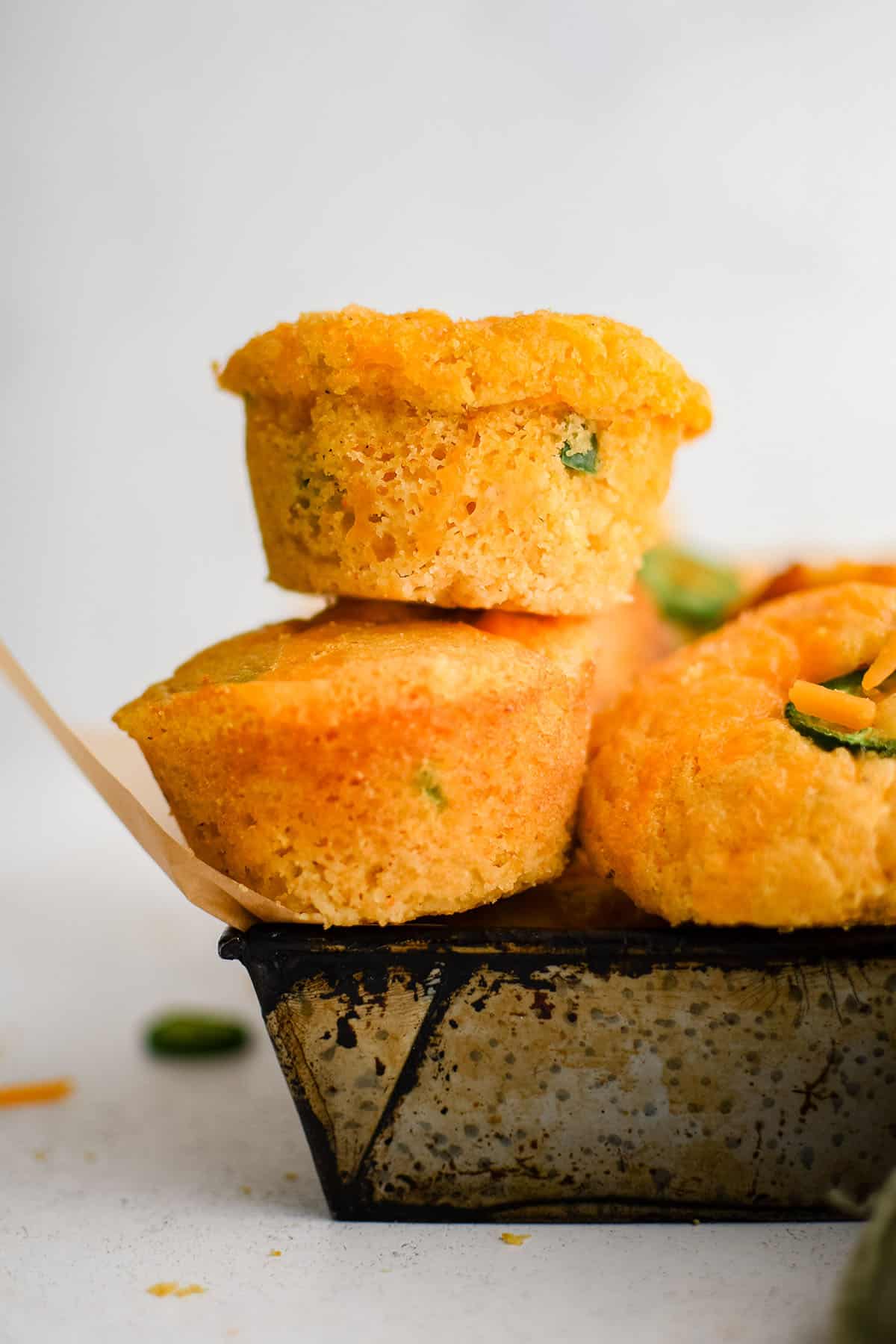 jalapeno cheddar corn muffins stacked on top of each other