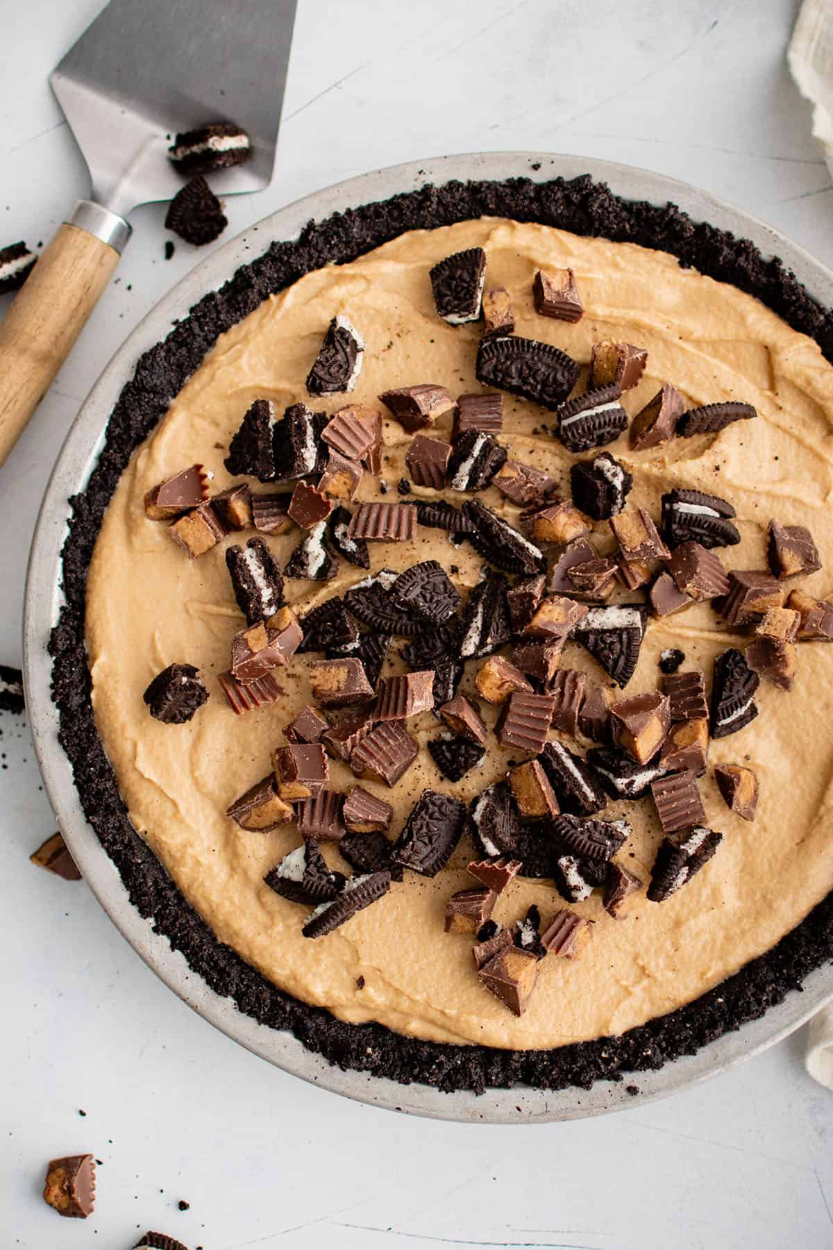 peanut butter pie in a pie pan topped with peanut butter cups
